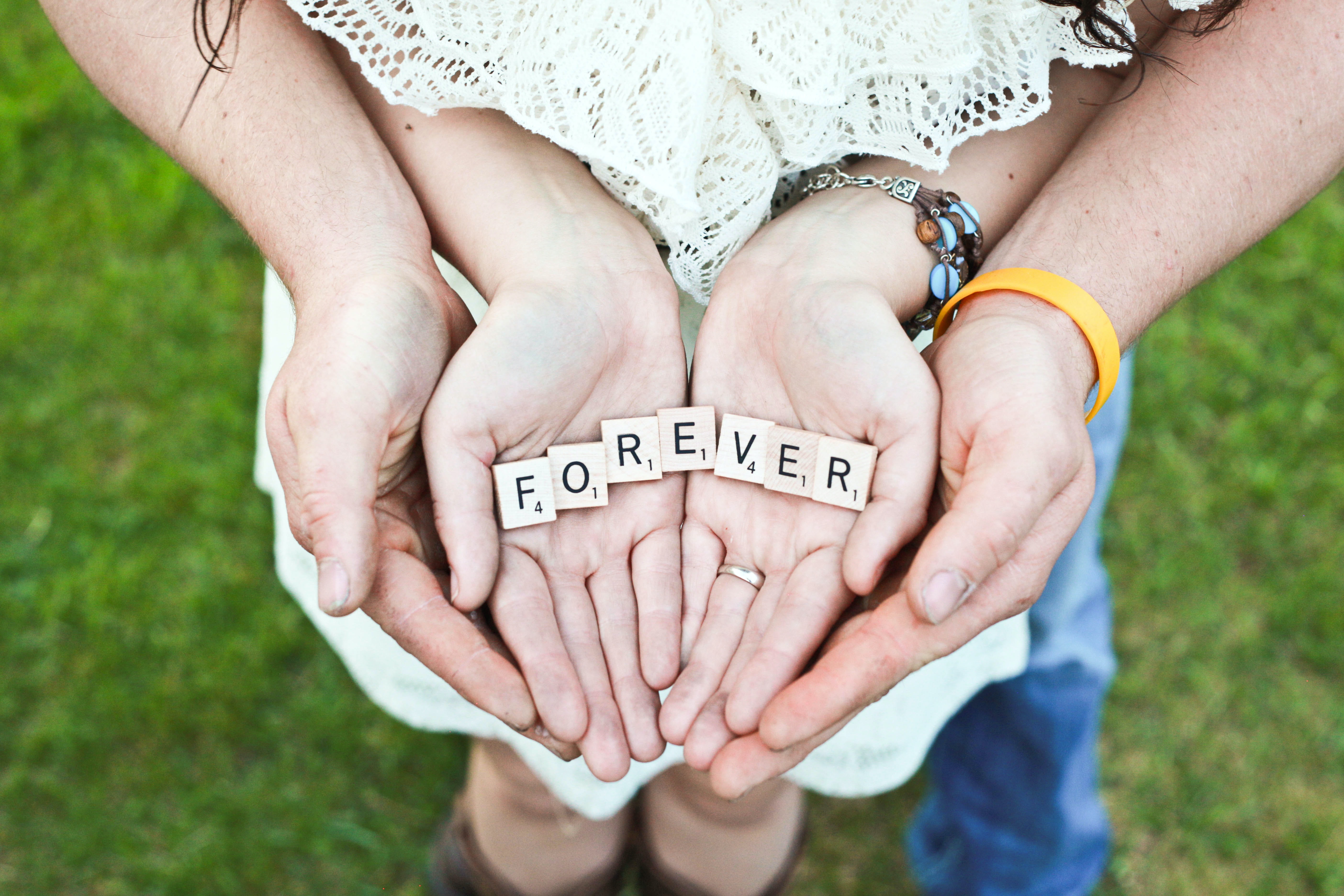 Couple cupping hands, in the center letter squares depicting the word Forever.. save your relationship with Marriage Counseling Therapists in Miami