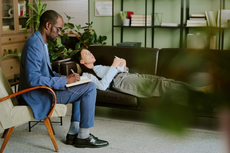 Therapist Taking Notes While Listening to Patient